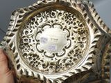 a person holding a silver plate in their hand