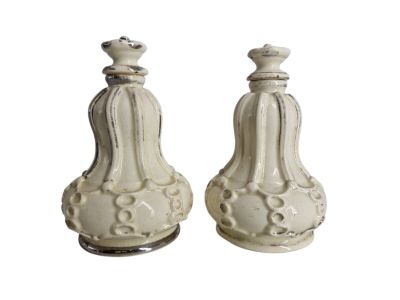 pair of white ceramic salt and pepper shakers on a white background