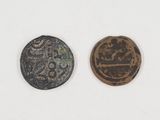 two ancient coins, one of which has a face and the other of which has a face