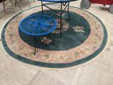 a blue table and two blue chairs in the middle of a living room