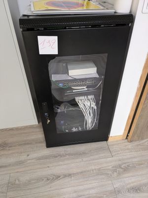 an image of a small black refrigerator in a kitchen