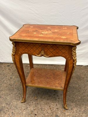 an old wooden table with a shelf on top of it next to a white wall