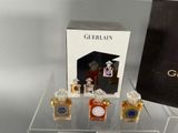 three bottles of perfume sitting on a clear table