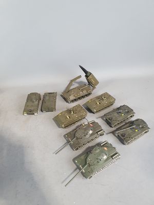 a lot of toy army tanks on a white surface