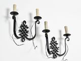 pair of black wrought sconces with pinecones on each of them