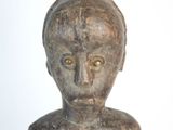 a statue of a man with a head on a table