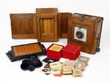 a group of old cameras and other items on a white surface