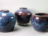 three vases that are sitting on a table