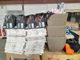 a large pile of books on a carton in a warehouse