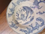a blue and white plate with a design on it on a table