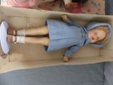 a doll that is sitting in a box on the floor