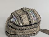 a hat that is sitting on a table next to a pair of scissors