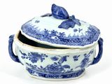 a blue and white bowl with a lid and a bird on it
