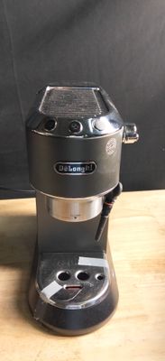 a black coffee maker sitting on a wooden table