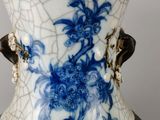 a blue and white vase sitting on a table