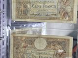 two old bank notes in a clear plastic case