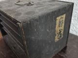 an old metal box sitting on a wooden table