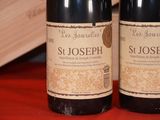 two bottles of wine that are sitting on a table