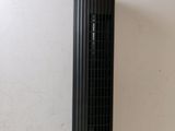 a black tower fan sitting on a table next to a white wall