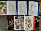 several pages of art work are spread out on a table
