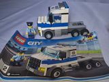 a lego city truck with a police officer and a police car