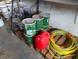 many cans of paint and hoses sitting on a pallet