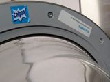 a close up of a washing machine with a sticker on it