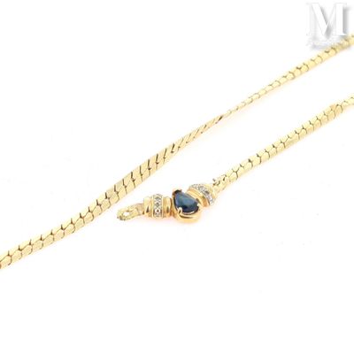 a gold chain with a blue stone on it