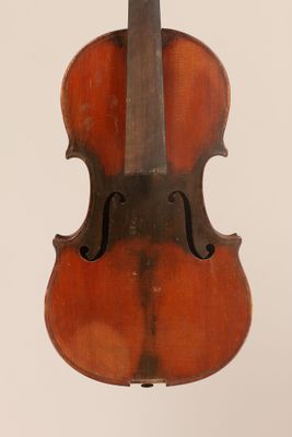 an old violin sitting on top of a white surface