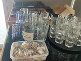 a table with a lot of glasses and a tray of cookies on it