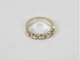 a close up of a gold ring on a white surface
