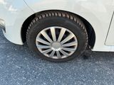 a close up of a tire on a white car
