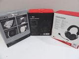 two boxes of headphones sitting on top of a white table