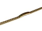 a close up of a gold bracelet on a white background