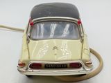 yellow and black toy car with a cord attached to the back of it