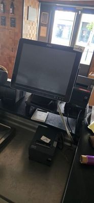 a desk with a computer monitor and a printer on it