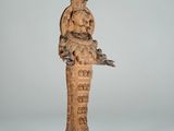 an old wooden statue of a woman holding a bird