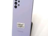 the back of a purple samsung galaxy s20 with a barcode sticker on it
