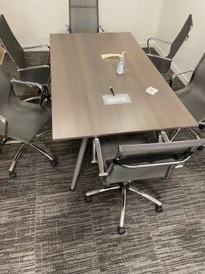 an image of a conference table and chairs in a conference room