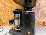 a black coffee grinder sitting on a counter top