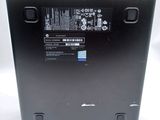 the back of a laptop with a battery on top of it