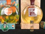 three bottles of perfume sitting next to each other on a table
