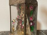 a small glass case with a figurine inside of it