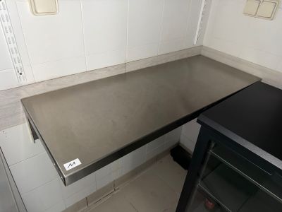 a black counter top in a kitchen with a black oven