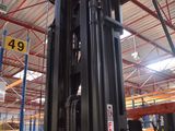 a forklift in a warehouse with a number plate on it