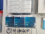 a lot of boxes of toothpaste and toothbrushes on the counter