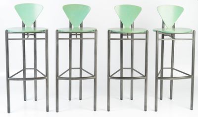 three green bar stools sitting next to each other on a white surface