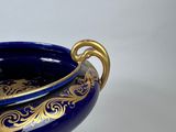 an image of a blue and gold vase on a white background