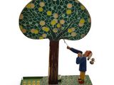 a figurine of a man holding a bird in front of a tree
