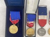 an assortment of medals and medals are displayed in a blue box